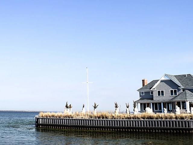 A shingle-style home right on the water behind a bulkhead