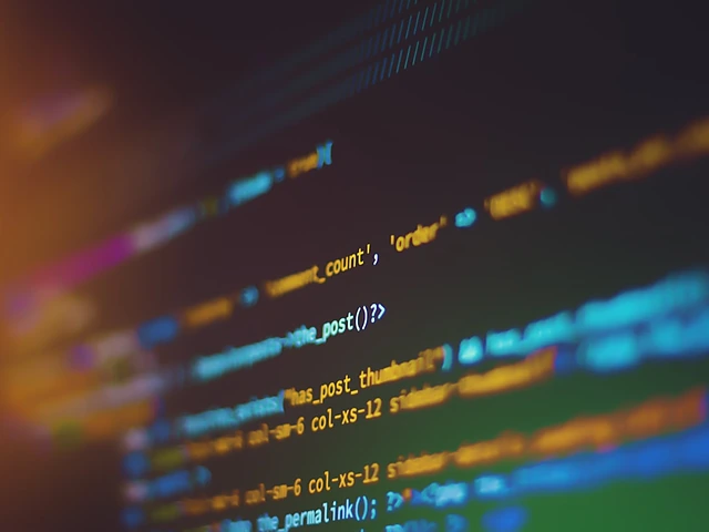 Lines of code glowing on a screen in shallow focus