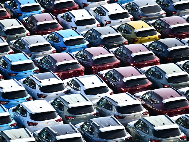Rows of new cars lined up on a dealer lot