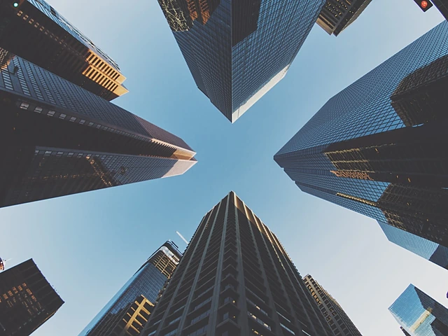 Looking up at high-rise buildings against a clear sky