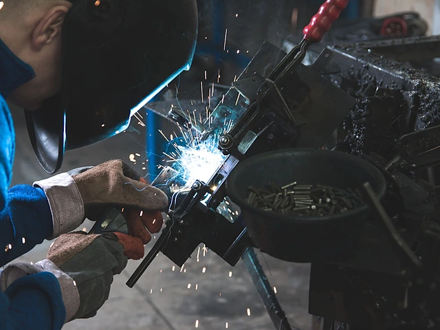 A welder at work with sparks flying